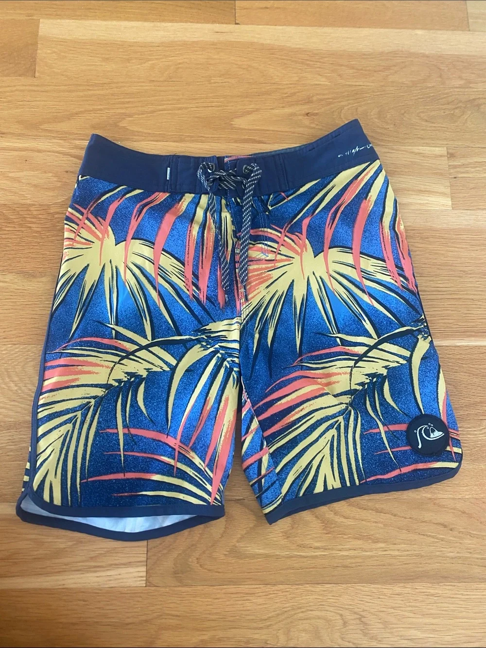 Quiksilver Navy Board Shorts with Yellow & Coral Palm Print. Size 26 or boys 12